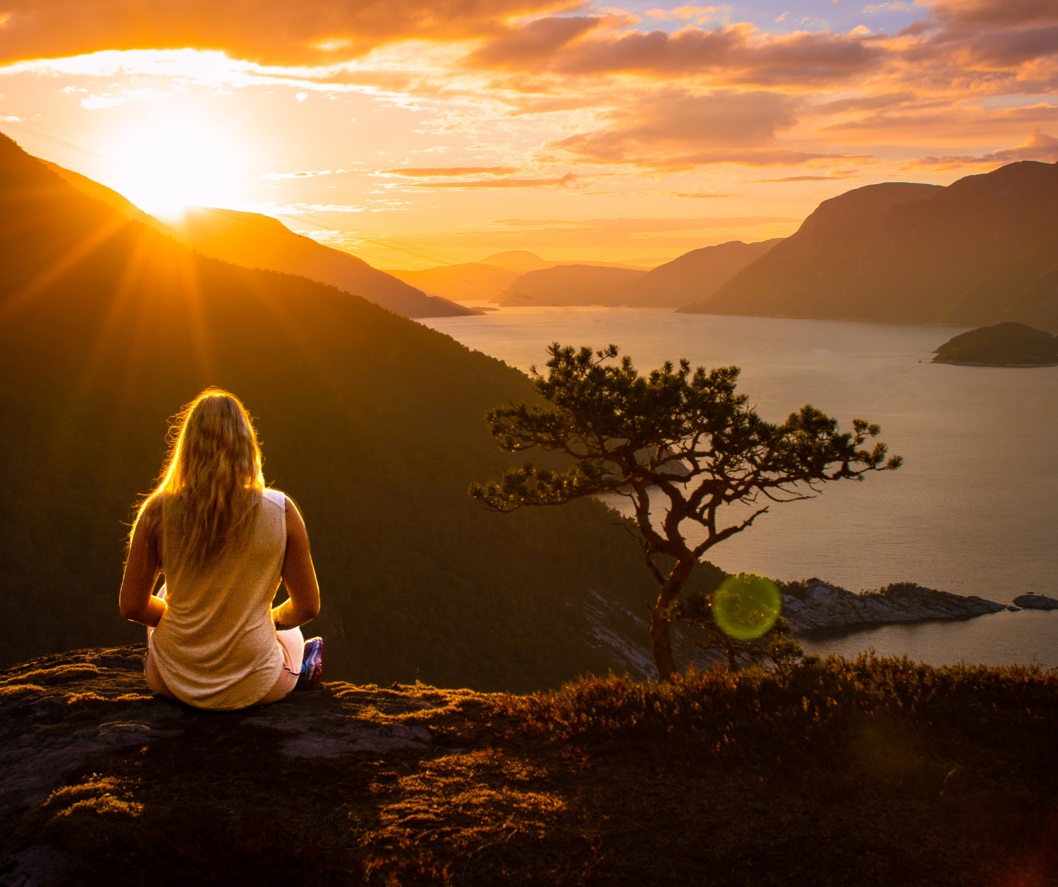 Person contemplating the landscape at summer solstice sunset
